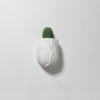 Wall-mounted white planter with a rough, textured surface, holding a small cactus