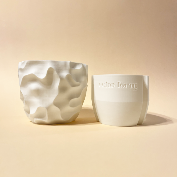 White 3D-printed planter with sculptural surface texture shown alongside its removable drainage insert in beige background