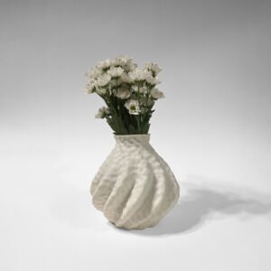 White 3D-printed sculptural vase with a wave-like surface, holding a bouquet of white daisies