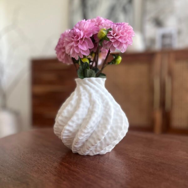 Astraeus white vase styled in a neutral-toned modern interior with floral stem